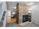 Living room with fireplace and view to the kitchen and stairs at 2291 S Jasper Way # B, Aurora, CO 80013