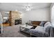 Living room showcasing a stone fireplace and access to the kitchen at 2291 S Jasper Way # B, Aurora, CO 80013