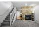 Cozy living area featuring a brick fireplace and staircase nearby at 2291 S Jasper Way # B, Aurora, CO 80013
