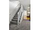 Carpeted staircase with a white railing, providing access to the upper level of the home at 2291 S Jasper Way # B, Aurora, CO 80013