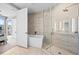 Bright bathroom featuring a glass shower, soaking tub, and stylish tile at 4200 W 17Th Ave # 621, Denver, CO 80204