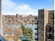 Serene building view overlooking a calm lake and cityscape, complete with distant buildings and clear blue skies at 4200 W 17Th Ave # 621, Denver, CO 80204