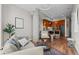 Open-concept living space featuring modern decor, a concrete pillar and hardwood flooring at 4200 W 17Th Ave # 621, Denver, CO 80204