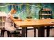 Bright studio space featuring a large wooden table and colorful mural wall at 4200 W 17Th Ave # 621, Denver, CO 80204