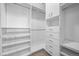 Spacious walk-in closet with custom shelving, drawers, and ample hanging space, perfect for organized storage at 4200 W 17Th Ave # 621, Denver, CO 80204
