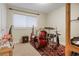 Spare bedroom featuring drum kit, guitar, and musical instruments on a patterned rug at 3401 S Glencoe St, Denver, CO 80222
