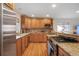 Modern kitchen features stainless steel appliances, granite countertops, and custom wood cabinetry at 3401 S Glencoe St, Denver, CO 80222