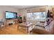 Cozy living area with hardwood flooring, a large window, and comfortable seating at 3401 S Glencoe St, Denver, CO 80222