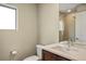 Clean bathroom featuring a glass door shower, modern vanity, and neutral color palette at 15525 W La Salle Ave, Lakewood, CO 80228