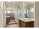 Modern bathroom features a vanity and a glass shower with dual shower heads and a built in shelf at 15525 W La Salle Ave, Lakewood, CO 80228