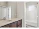 Bathroom with a modern vanity, large mirror, and a shower-over-tub with white tile surround at 15525 W La Salle Ave, Lakewood, CO 80228