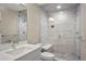 Bright bathroom with a glass shower, dual shower heads, marble tiles, and a spacious vanity at 15525 W La Salle Ave, Lakewood, CO 80228
