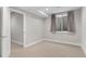 Bedroom with neutral walls and plush carpet, and a window to bring in light at 15525 W La Salle Ave, Lakewood, CO 80228