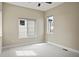 Spacious bedroom with neutral walls and flooring, multiple windows, and ceiling fan at 15525 W La Salle Ave, Lakewood, CO 80228