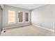 Light-filled bedroom with neutral walls, plush carpet and three large windows at 15525 W La Salle Ave, Lakewood, CO 80228