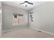 Cozy bedroom with a ceiling fan, large window, neutral walls, and plush carpet at 15525 W La Salle Ave, Lakewood, CO 80228