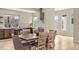 Bright dining area featuring a modern chandelier, stylish finishes, and a view of the kitchen at 15525 W La Salle Ave, Lakewood, CO 80228