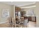 Open concept dining area featuring stylish lighting, modern finishes, and a view of kitchen at 15525 W La Salle Ave, Lakewood, CO 80228