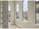 Inviting foyer featuring light hardwood floors, a white front door, and abundant natural light through large windows at 15525 W La Salle Ave, Lakewood, CO 80228