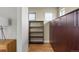 Modern hallway features beautiful built-in cabinetry, open shelving, and tile flooring at 15525 W La Salle Ave, Lakewood, CO 80228