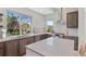 Contemporary kitchen features modern appliances, gray tile backsplash, spacious island, and abundant natural light at 15525 W La Salle Ave, Lakewood, CO 80228