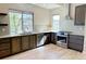 Modern kitchen with stainless steel appliances, granite countertops, and ample cabinet space at 15525 W La Salle Ave, Lakewood, CO 80228