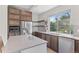 Stylish kitchen boasts stainless steel appliances, a large island, hardwood floors, and sleek countertops at 15525 W La Salle Ave, Lakewood, CO 80228