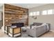 Cozy living room featuring a modern fireplace, wood accent wall, and comfortable seating at 15525 W La Salle Ave, Lakewood, CO 80228