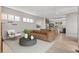 Bright living space showcases a modern sofa, stylish furniture, hardwood flooring, and open access to the kitchen at 15525 W La Salle Ave, Lakewood, CO 80228