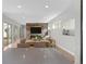 Spacious living room with natural light, wood accent wall, and open floor plan at 15525 W La Salle Ave, Lakewood, CO 80228