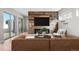 Modern living room boasts a media center wall with a fireplace, sleek furniture, and bright natural light at 15525 W La Salle Ave, Lakewood, CO 80228