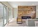 Bright living room with sliding glass doors, hardwood floors, modern fireplace, and unique wood accent wall at 15525 W La Salle Ave, Lakewood, CO 80228