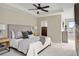 A spacious main bedroom featuring a ceiling fan, a large bed and neutral decor at 15525 W La Salle Ave, Lakewood, CO 80228