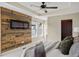 Inviting primary bedroom boasts wood accent wall, fireplace and ample natural light at 15525 W La Salle Ave, Lakewood, CO 80228