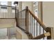Well-lit staircase features wood railing, metal balusters and carpeted steps at 15525 W La Salle Ave, Lakewood, CO 80228