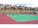 Community tennis court with green playing surface, black fencing, and seating at 15525 W La Salle Ave, Lakewood, CO 80228