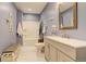 Bathroom featuring a vanity, toilet, and bathtub with shower in a calming blue color scheme at 11505 Conifer Ridge Dr, Conifer, CO 80433