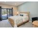 Cozy bedroom with a comfortable bed, sliding glass doors to the outside, and neutral decor at 11505 Conifer Ridge Dr, Conifer, CO 80433