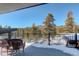 Outdoor deck area with stunning views of the surrounding mountains and evergreen trees at 11505 Conifer Ridge Dr, Conifer, CO 80433