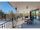 Outdoor deck perfect for entertaining with views of a snow-filled forest at 11505 Conifer Ridge Dr, Conifer, CO 80433