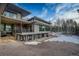Contemporary home features stone accents, a covered patio, metal railings, and large windows at 11505 Conifer Ridge Dr, Conifer, CO 80433