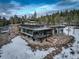 Stunning modern home with flat roofs, walls of windows, stone accents, and a large, open lower level at 11505 Conifer Ridge Dr, Conifer, CO 80433