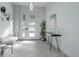 Inviting foyer featuring light gray tiled floors and walls, modern art, and a stylish black table at 11505 Conifer Ridge Dr, Conifer, CO 80433