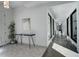 Stylish foyer featuring a sleek console table, artwork, and views into the hallway with large windows at 11505 Conifer Ridge Dr, Conifer, CO 80433