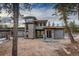 Contemporary home with a stone facade, stylish windows, and modern design elements on a sloped lot at 11505 Conifer Ridge Dr, Conifer, CO 80433