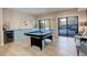 Spacious game room featuring a pool table, wet bar, and sliding doors to an outdoor patio at 11505 Conifer Ridge Dr, Conifer, CO 80433