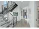 Hallway with hardwood floors, staircase, and natural light flowing throughout the home at 11505 Conifer Ridge Dr, Conifer, CO 80433