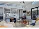 Inviting living room with stylish furniture, built-in shelving, view to deck, and an entertainment center at 11505 Conifer Ridge Dr, Conifer, CO 80433