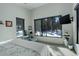 Comfortable main bedroom featuring view of treed lot, chair and ottoman, and contemporary decor at 11505 Conifer Ridge Dr, Conifer, CO 80433