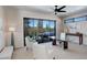 Bright office space features a glass desk, neutral decor, and mountain views from the sliding glass doors at 11505 Conifer Ridge Dr, Conifer, CO 80433